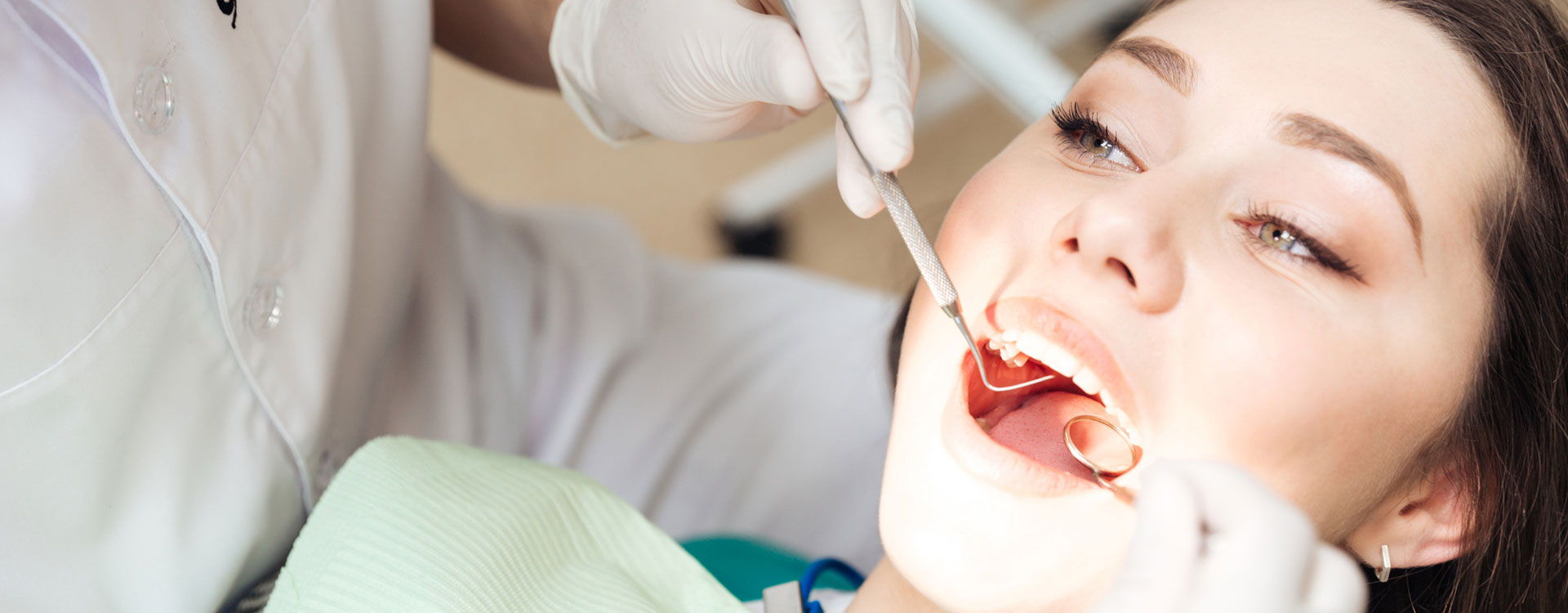 Dentist doing dental treatment to a woman